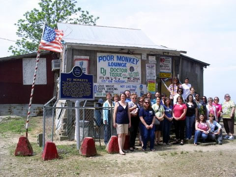 Art teachers in front of Po' Monkey's Lounge